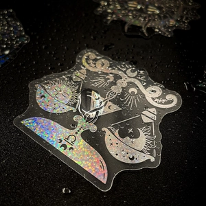 Macro shot of waterproof laser holographic mystic stickers with moon and sun patterns