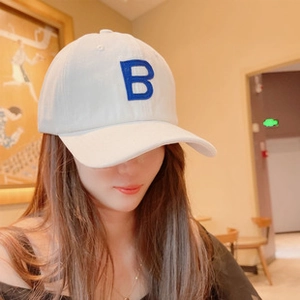 Detail of blue letter B embroidery on a light gray cotton knit beanie for women
