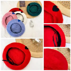 Detail of soft plush beret hats showing inner adjustable drawstring and heart patch embroidery