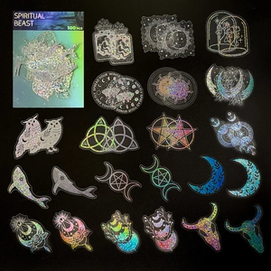 Detail of 100pcs holographic mystical stickers featuring owls and celestial patterns