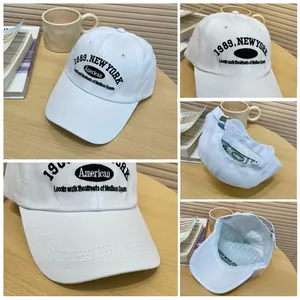Detailed views of white cotton baseball cap with New York embroidery and metal buckle