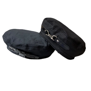 Black canvas beret with industrial metal clip and cyberpunk strap details in studio view