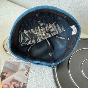Detail view of the blue corduroy docker cap with high-quality lining and reinforced tape