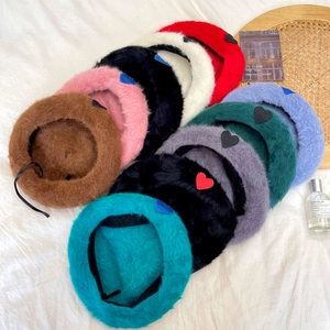 Plush angora-style beret hats in various colors with heart embroidery for winter