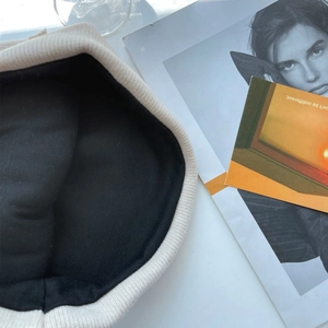 Detail of the dual-layer ribbed knit beanie with soft black warm inner lining fabric