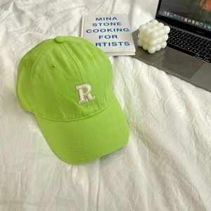 Detailed shot of neon green cotton baseball cap with white 3D letter R embroidery
