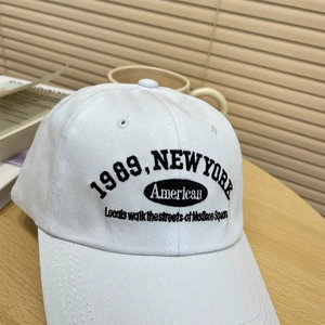 Close-up of retro white cotton baseball cap with 1989 New York embroidery detail
