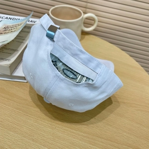 Close-up of white cotton baseball cap with adjustable metal buckle and fabric strap