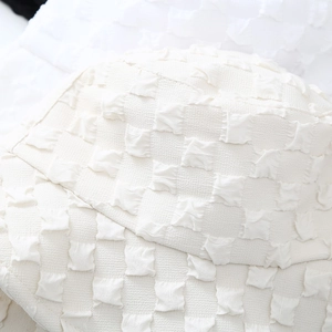 Minimalist off-white seersucker bucket hat with bubble texture for women in plain view
