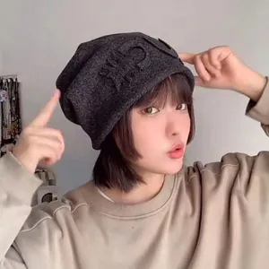Dark grey slouchy knitted beanie with embossed letter detail for a casual layered look