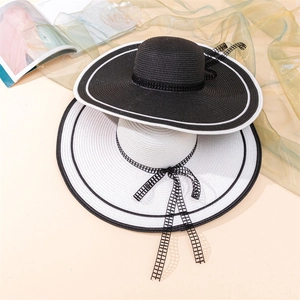 Wide brim straw sun hat with plaid ribbon bow for beach UV protection in black and white