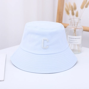 Detailed close-up of light blue cotton bucket hat with white embroidered letter C