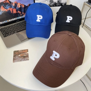 Detail of baseball caps with 3D embroidered P logo and high-density cotton fabric texture