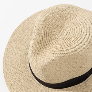 Detailed close-up showing the fine beige paper straw weave and black ribbon on the sun hat
