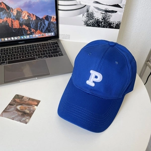 Close-up of the 3D embroidered white P letter on a dark blue cotton baseball cap