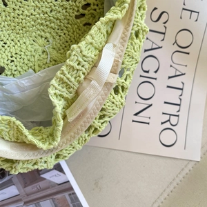 Détail macro du sac au crochet vert lime montrant le tricot ajouré et le cordon de serrage