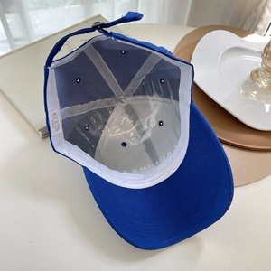 Detail view of cotton baseball cap interior with sweatband, seams, and metal buckle strap