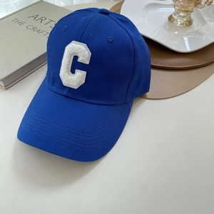 Close-up of royal blue baseball cap featuring white towel-embroidered letter C