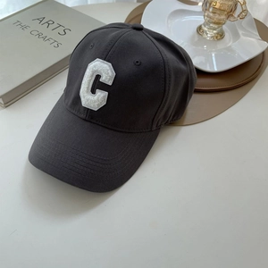 Detailed view of dark grey cotton baseball cap with white towel embroidered letter C