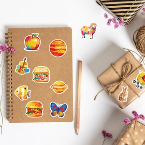 Artistic oil painting style stickers shown on a kraft notebook and gift box packaging