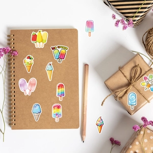 Close-up of colorful ice cream stickers decorating a journal with hand-drawn designs