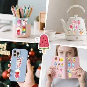Colorful summer ice cream stickers decorating a phone case and stationery items