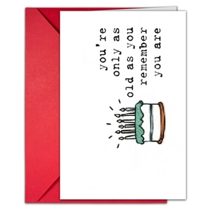 Close-up of birthday card with humor text and red envelope for creative gifting