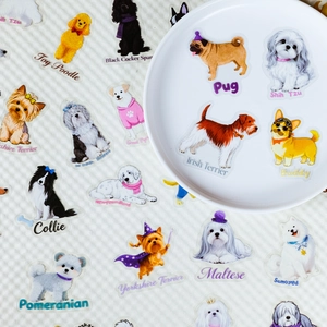 Macro view of clear PET dog stickers featuring Poodle and Samoyed on a white ceramic plate