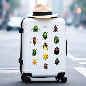 Variety of colorful beetle and insect stickers applied to a white suitcase for decoration