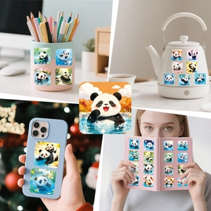 Waterproof cute panda stickers displayed on a notebook, cup, and phone case