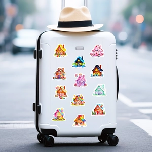 Colorful candy house stickers applied on a white suitcase in an outdoor urban setting