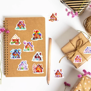 Flat lay of colorful candy house stickers with vintage notebook and wooden pencil
