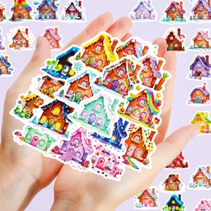Macro view of assorted colorful gingerbread house stickers held in hand for size context