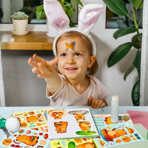 Girl playing with cute capybara stickers in a cozy DIY craft setting with natural light