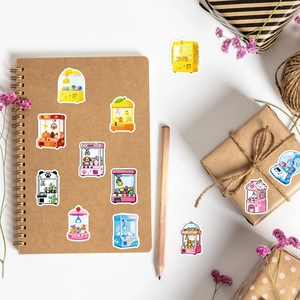 Detailed close-up of cute crane machine stickers on a kraft paper notebook for journaling