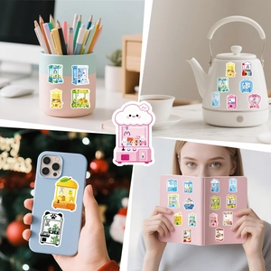 Cute cartoon doll machine stickers shown on desk supplies, laptop and phone case