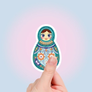 Detail shot of a colorful Russian Matryoshka doll sticker with blue and floral patterns