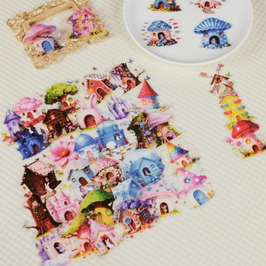 Close-up of fairy tale mushroom house PET stickers with vintage gold frame on a tray