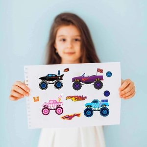 Close-up of monster truck stickers for kids with colorful puzzle pieces and creative faces