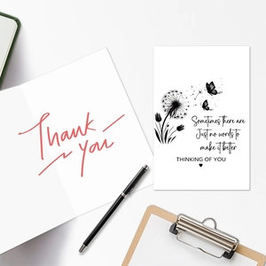Flat lay of mourning card set with dandelion motifs and heartfelt sympathy message