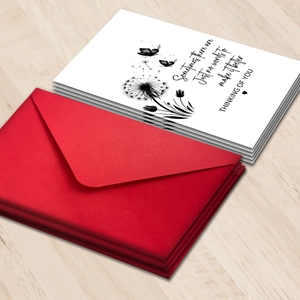 Funeral sympathy card set with dandelion pattern and dark red envelope on wooden table