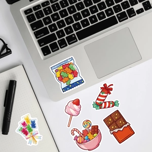 Waterproof candy stickers displayed on a laptop and notebook for creative decoration