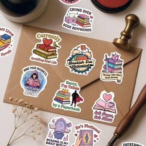 Close-up of pink bookish stickers on vintage envelope with artistic stationery props