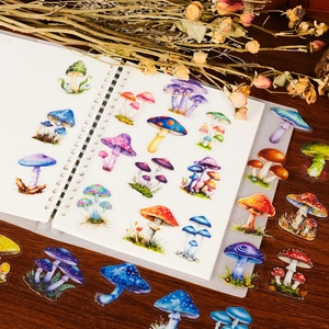 Close-up of realistic mushroom stickers on a vintage wooden desk with dried roses