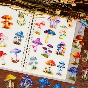 Macro shot of realistic colorful mushroom PET stickers arranged on a grid notebook