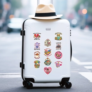 Pink bookworm stickers featuring cats and skulls on a white suitcase in city setting
