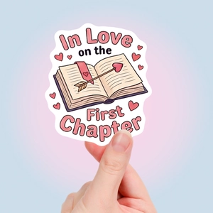 Close-up of pink book lover sticker with In Love on the First Chapter text design