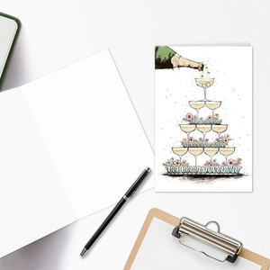 Macro view of hand-drawn champagne tower wedding card with blank interior for messaging