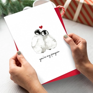Romantic 'You're My Penguin' card with a red envelope on a festive wooden background