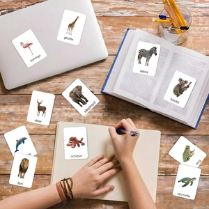 Educational animal flashcard set with realistic photos on a minimalist wooden desktop
